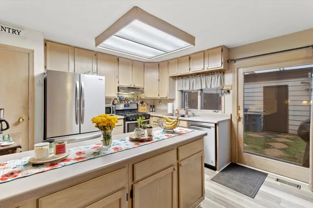 a kitchen with refrigerator and cabinets