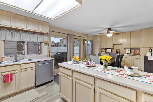 a kitchen that has a lot of cabinets a sink and appliances in it