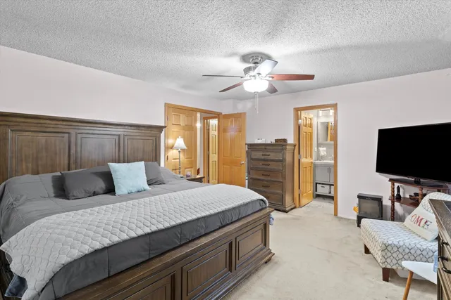 a bedroom with a bed and furniture with window