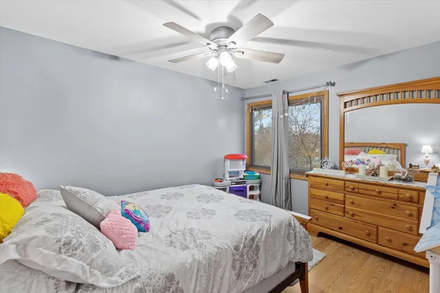 a bedroom with a bed and a dresser