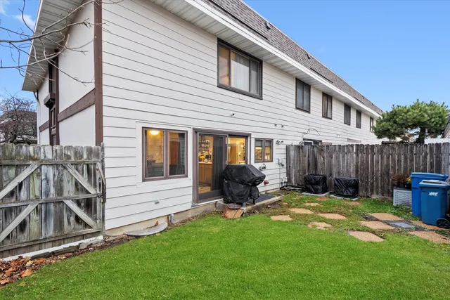 a view of a house with backyard and furniture