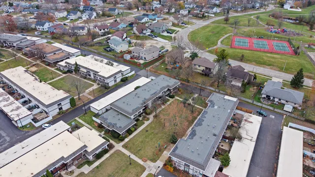 an aerial view of residential houses with outdoor space