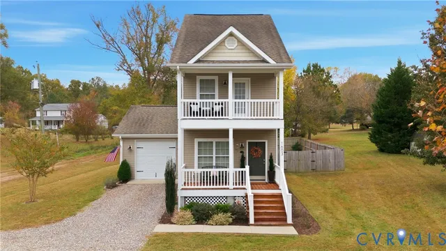 a front view of a house with a yard garage and outdoor seating