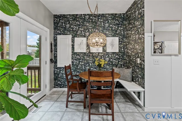 a kitchen with stainless steel appliances granite countertop a refrigerator a sink a stove top oven a counter space and dining table