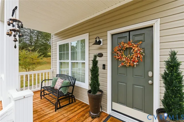 a view of a door with a bench and wooden floor