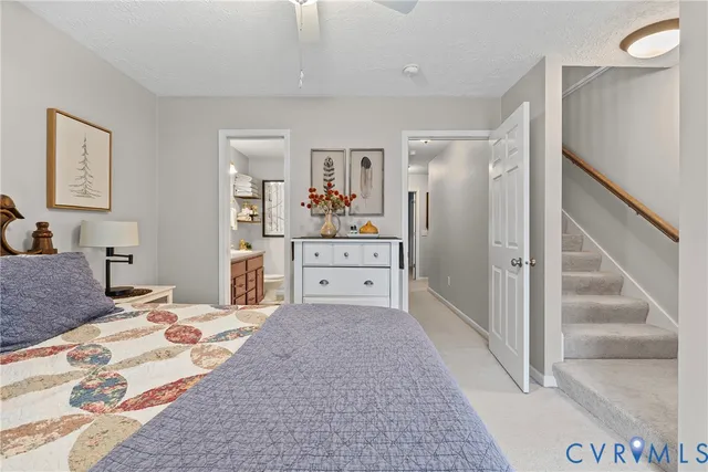 a large bed sitting in a bedroom next to a window and a wooden floor