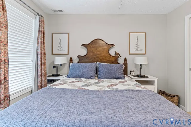 a bathroom with a granite countertop sink a toilet and a mirror