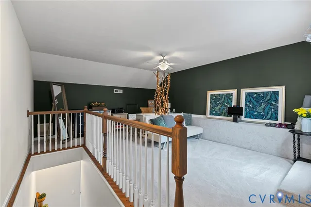 a living room with furniture and chandelier