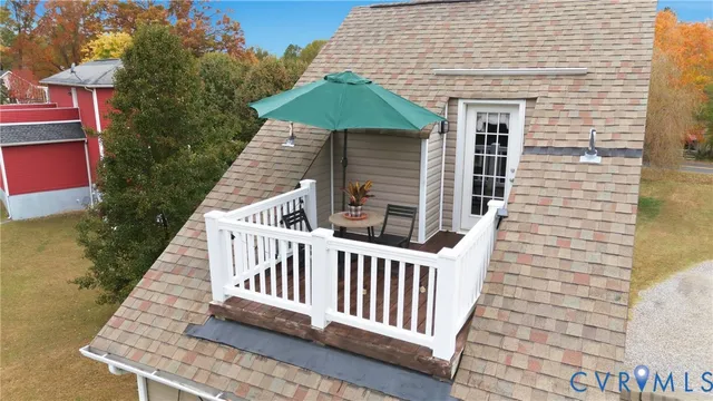 a view of balcony with furniture and umbrella
