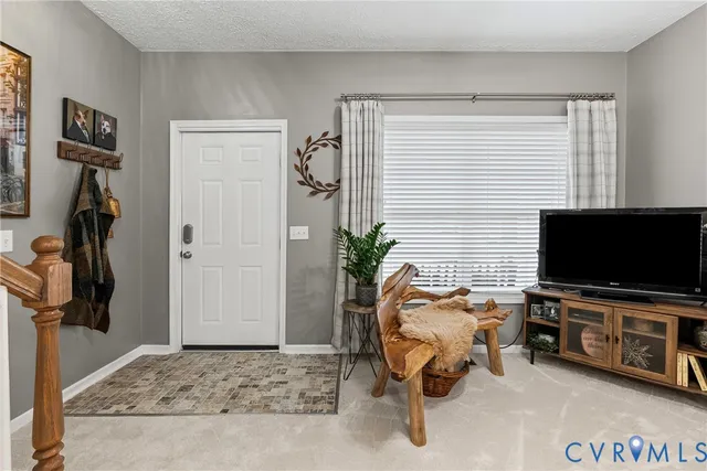 a view of a livingroom with workspace and a window