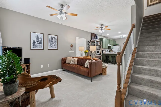 a living room with furniture and a potted plant