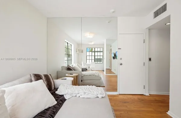 a bedroom with furniture and a large window