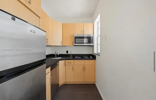 a kitchen with stainless steel appliances granite countertop a sink and a stove