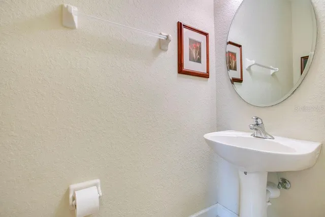 a bathroom with a sink and mirror