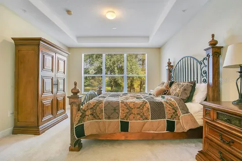 a bed sitting in a bedroom next to a window