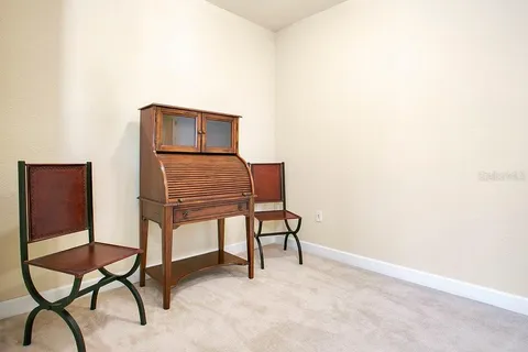 a view of chairs and table in a room