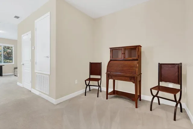 a view of a livingroom with furniture and a piano