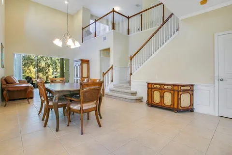 a dining room with furniture and a entryway