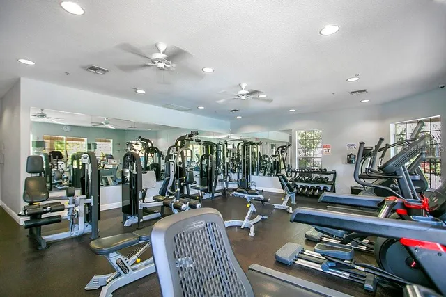 a living room with lots of gym equipment