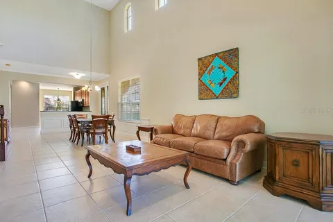 a living room with furniture a dining table and kitchen view