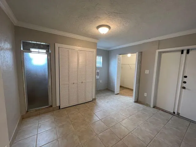 an empty room with closet and a bathroom