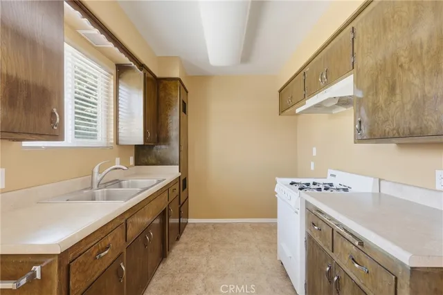 a kitchen with a sink stove and cabinets