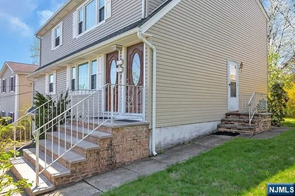 a view of a house with a yard and sitting area