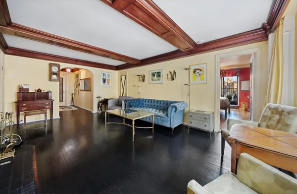 a living room with furniture and a dining table