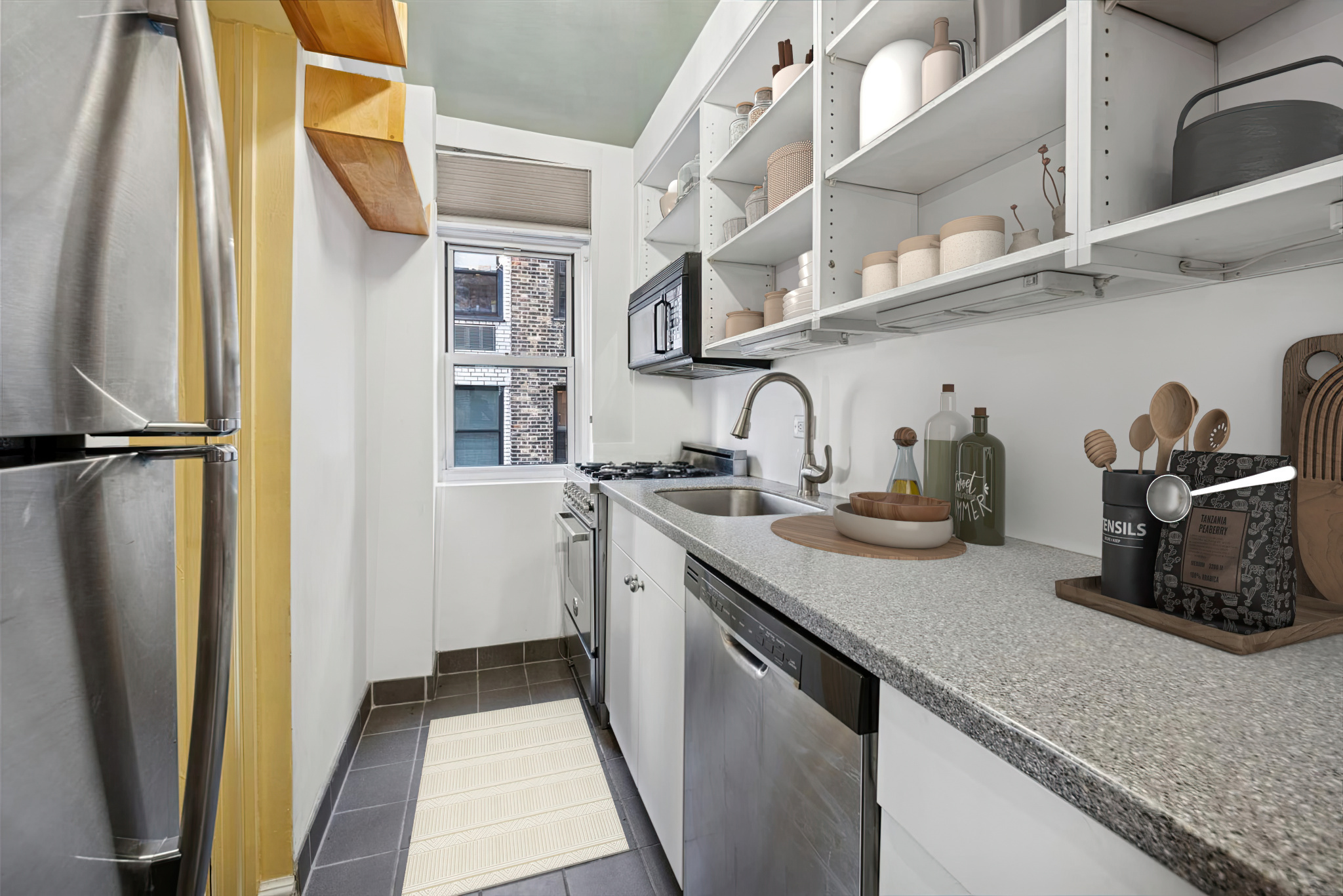 225 East 73rd Street, Unit 11D Manhattan, NY 10021 - Photo 5 of 12 a kitchen with stainless steel appliances granite countertop a sink and a refrigerator
