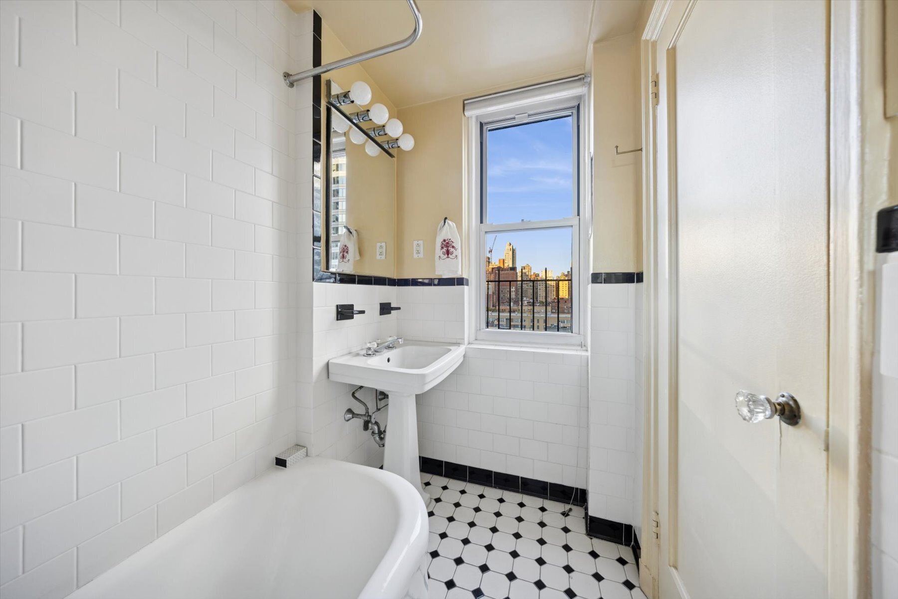 225 East 73rd Street, Unit 11D Manhattan, NY 10021 - Photo 8 of 12 a bathroom with a sink and a mirror