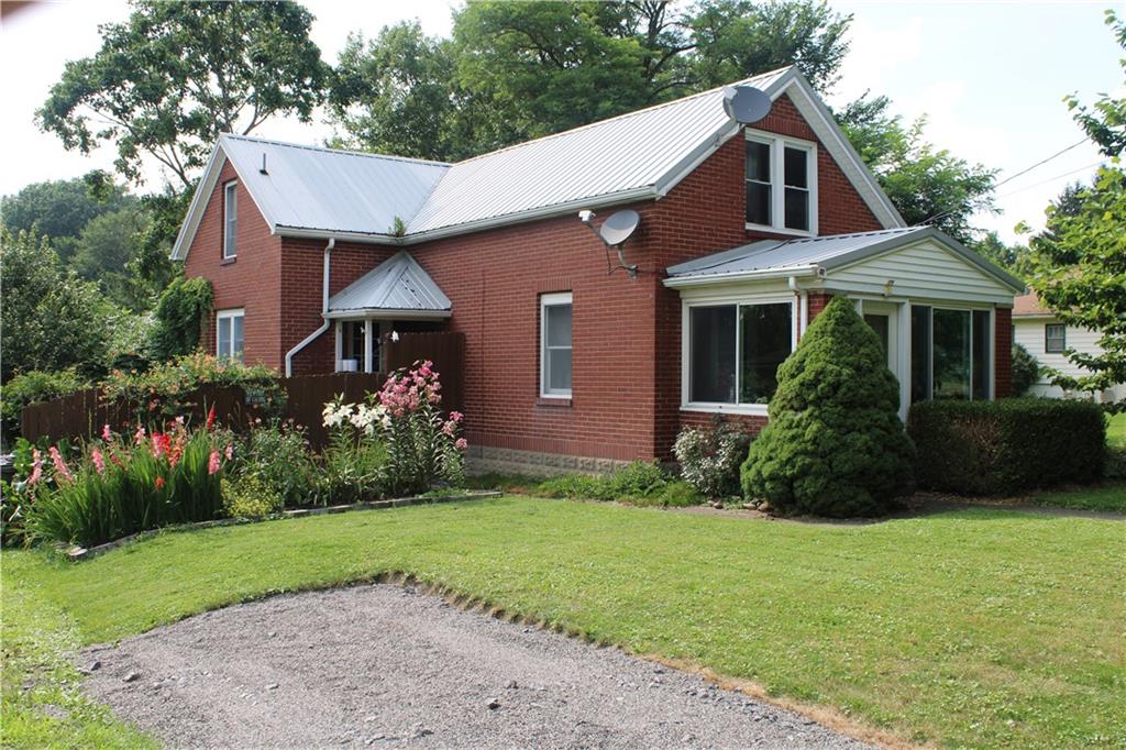 109 Country Club Road Butler, PA 16002 - Photo 1 of 18 a front view of a house with a garden and plants