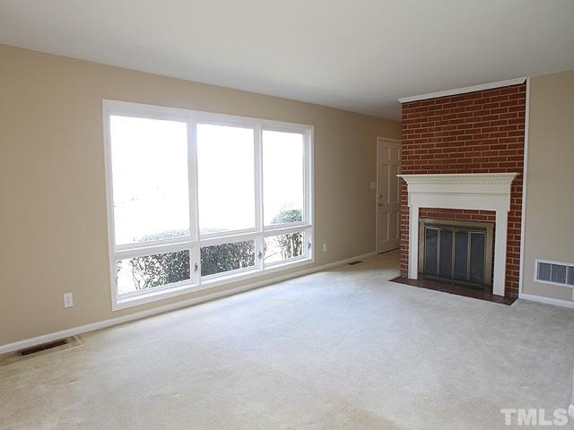 3609 Garner Road Raleigh, NC 27610 - Photo 3 of 13 another view of the living room showing fireplace. There are hardwoods under the carpet.