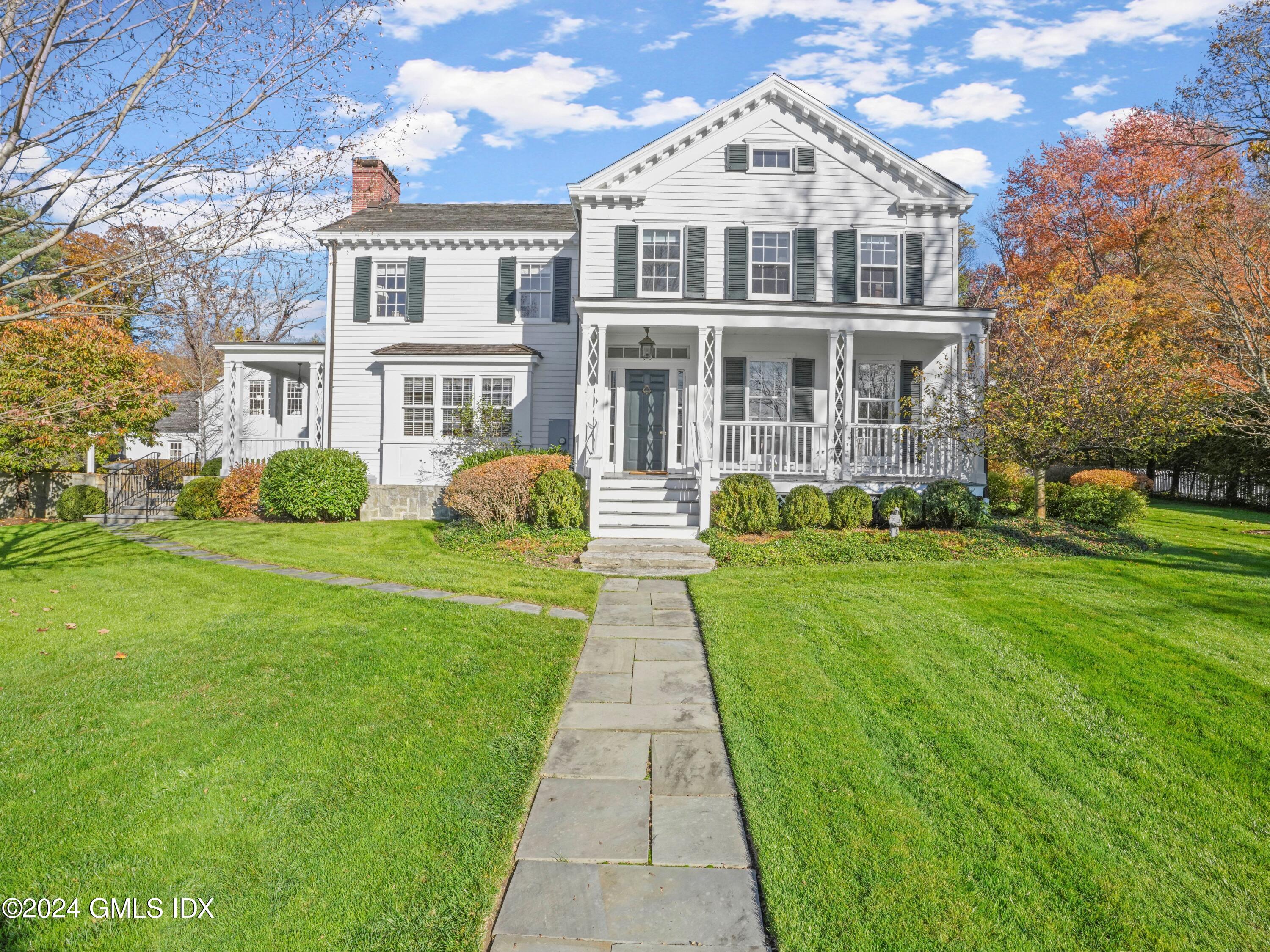 264 Taconic Road Greenwich, CT 06831 - Photo 1 of 36 a front view of a house with yard