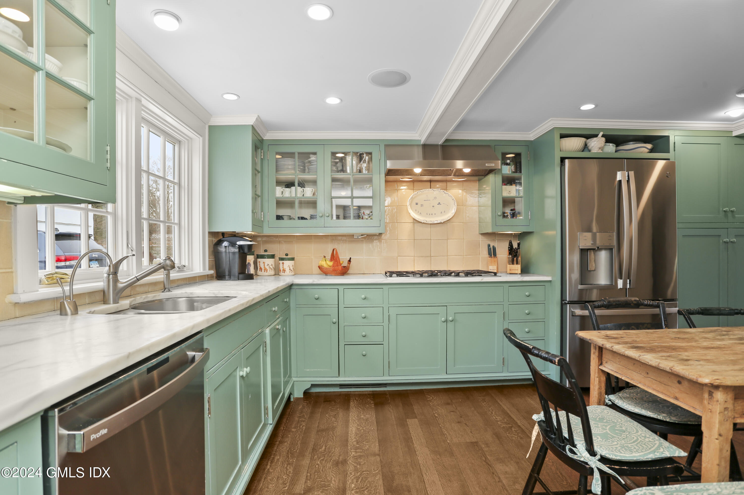 264 Taconic Road Greenwich, CT 06831 - Photo 12 of 36 a kitchen with sink cabinets and wooden floor