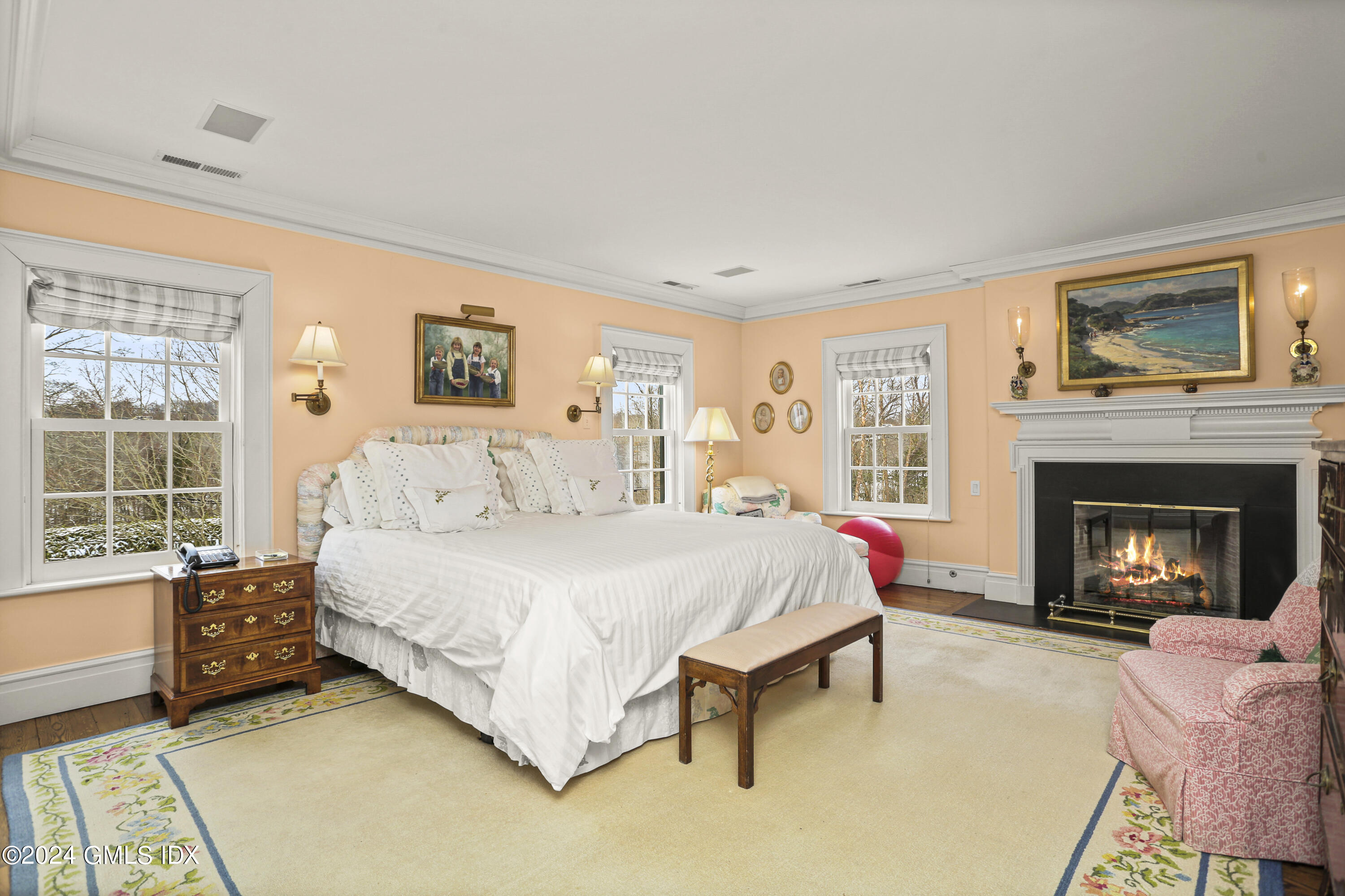 264 Taconic Road Greenwich, CT 06831 - Photo 16 of 36 a spacious bedroom with a bed and a fireplace