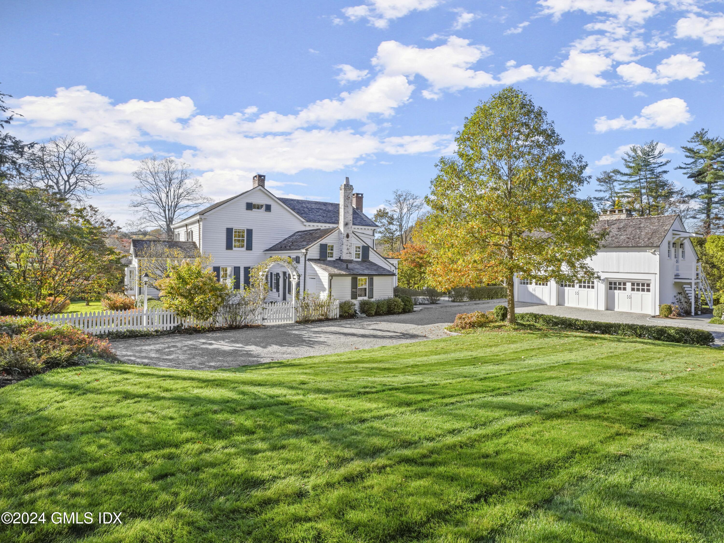264 Taconic Road Greenwich, CT 06831 - Photo 23 of 36 a view of a house with a big yard and large trees