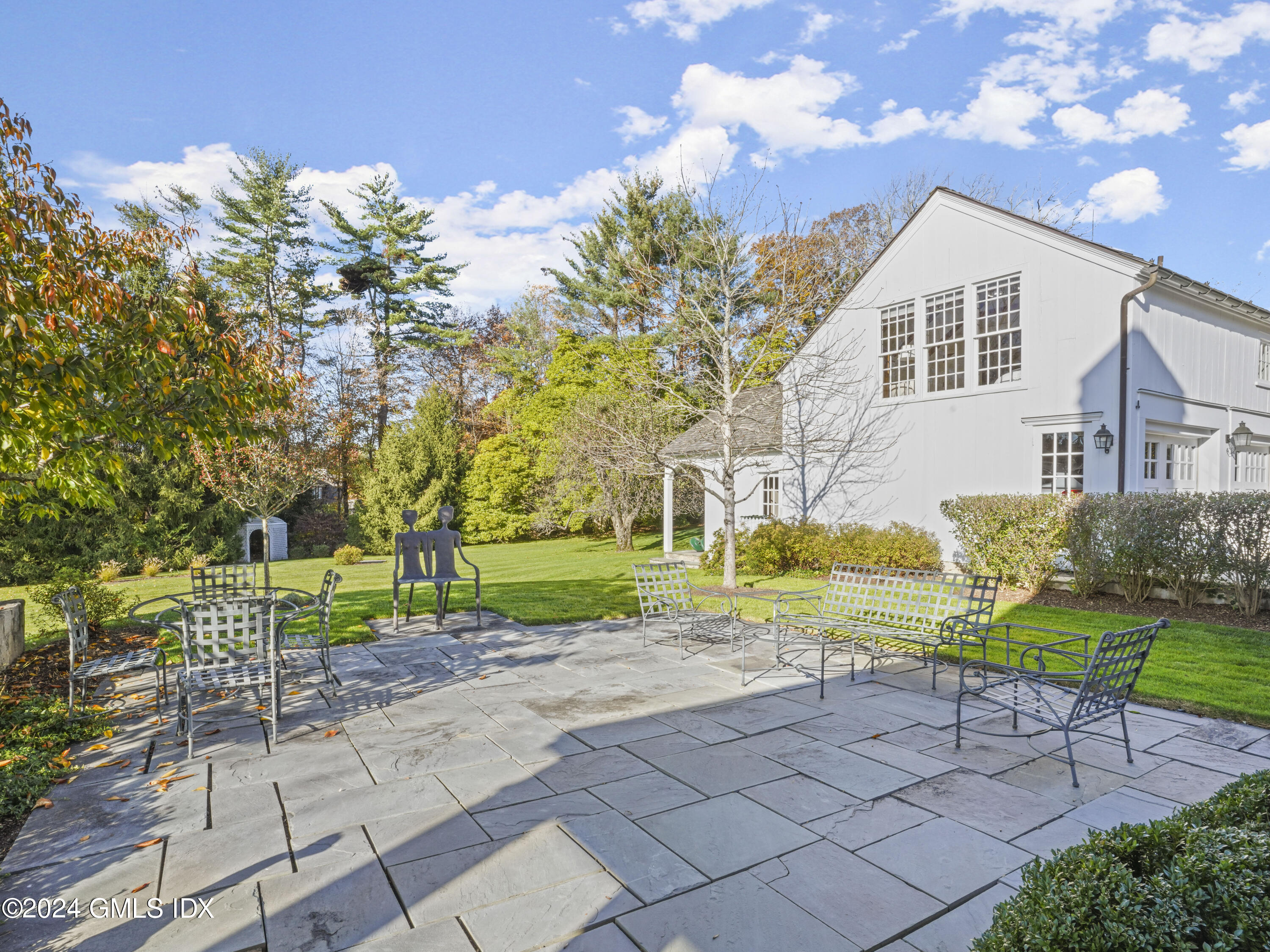 264 Taconic Road Greenwich, CT 06831 - Photo 31 of 36 a view of a house with a yard and sitting area