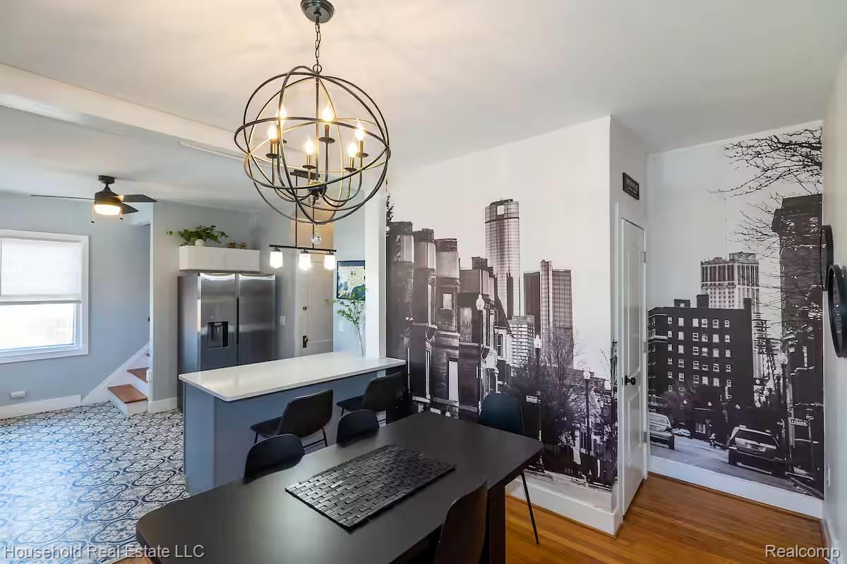 4446 Commonwealth Street Detroit, MI 48208 - Photo 18 of 28 Kitchen featuring ceiling fan, stainless steel fridge, a chandelier, light countertops, and light wood-type flooring