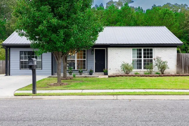 a view of a house with a swimming pool and a yard