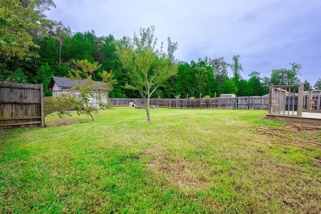 a front view of a house with a garden and trees