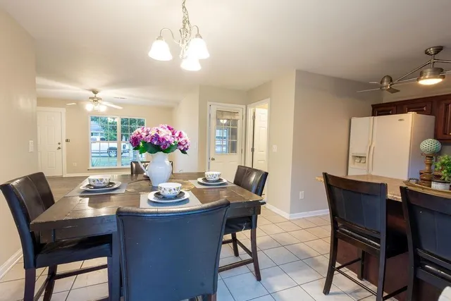 a view of a dining room with furniture and chandelier