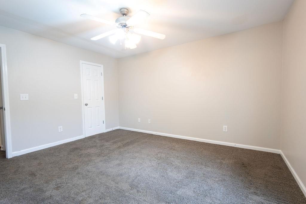 33 Northwest Hunters Glenn Road Northwest Rome, GA 30165 - Photo 8 of 19 an empty room with a fan & a ceiling fan