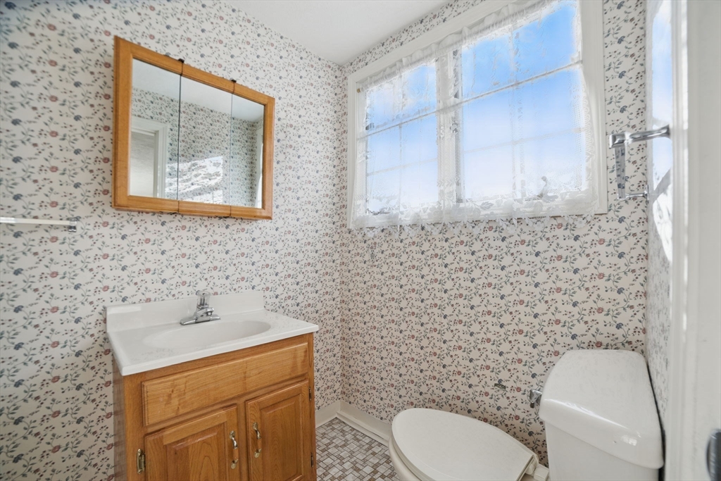 8 Ware Road Winchester, MA 01890 - Photo 15 of 25 a bathroom with a toilet sink and mirror