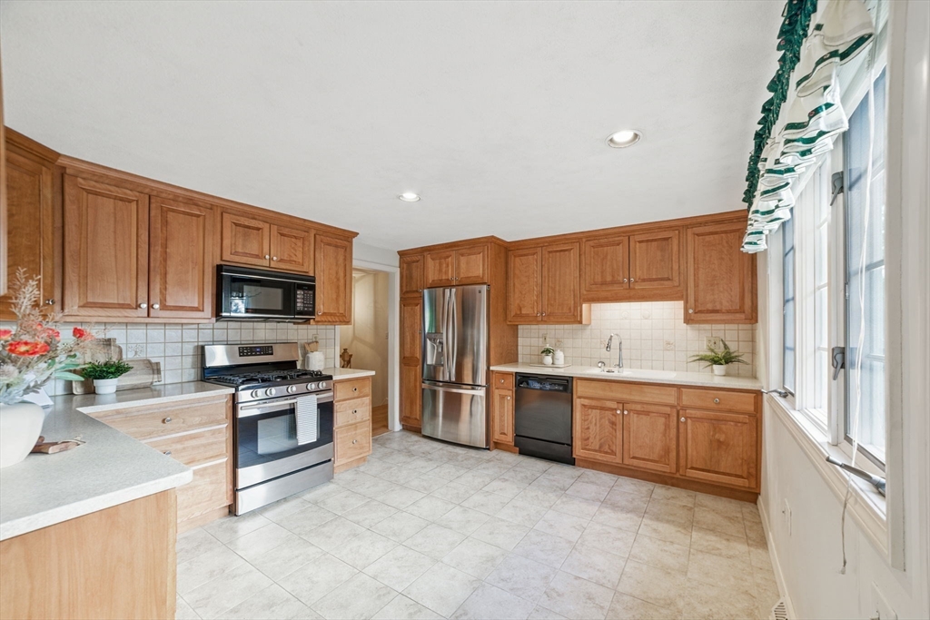 8 Ware Road Winchester, MA 01890 - Photo 5 of 25 a kitchen with stainless steel appliances granite countertop a stove top oven a sink dishwasher a refrigerator and a microwave
