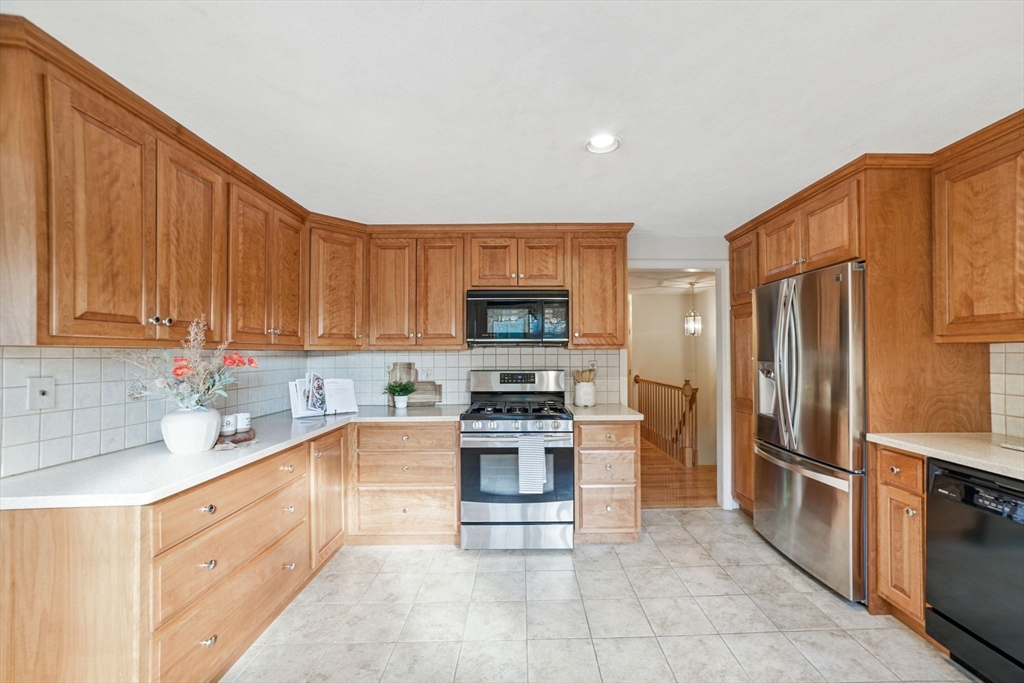 8 Ware Road Winchester, MA 01890 - Photo 6 of 25 a kitchen with stainless steel appliances a stove sink and refrigerator
