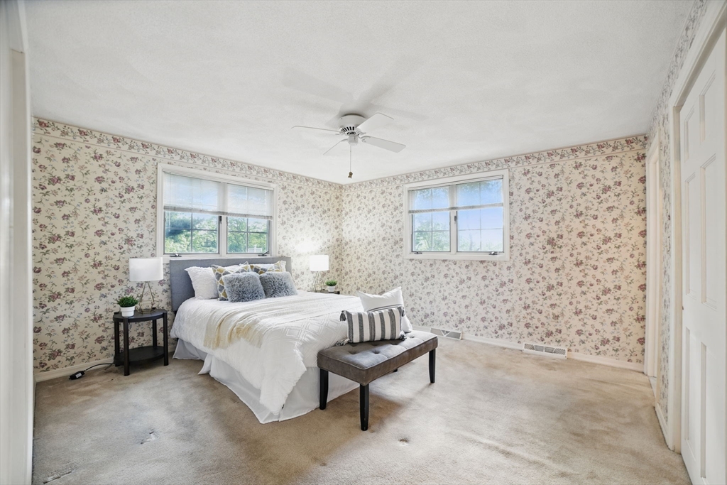 8 Ware Road Winchester, MA 01890 - Photo 9 of 25 a bedroom with a bed and a chair