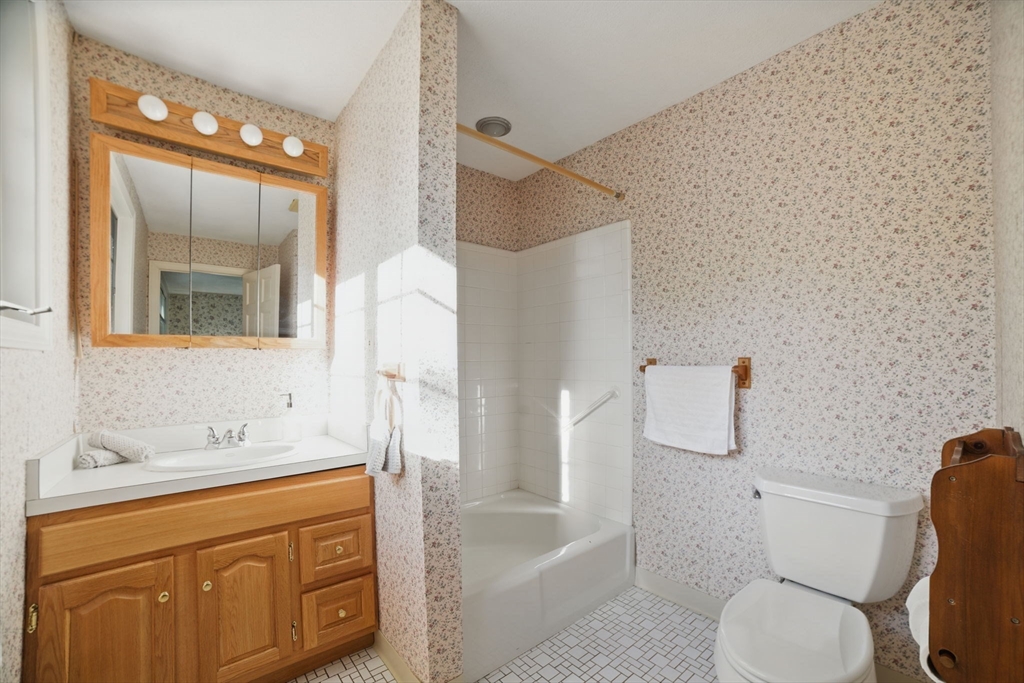 8 Ware Road Winchester, MA 01890 - Photo 10 of 25 a bathroom with a sink a toilet and bathtub