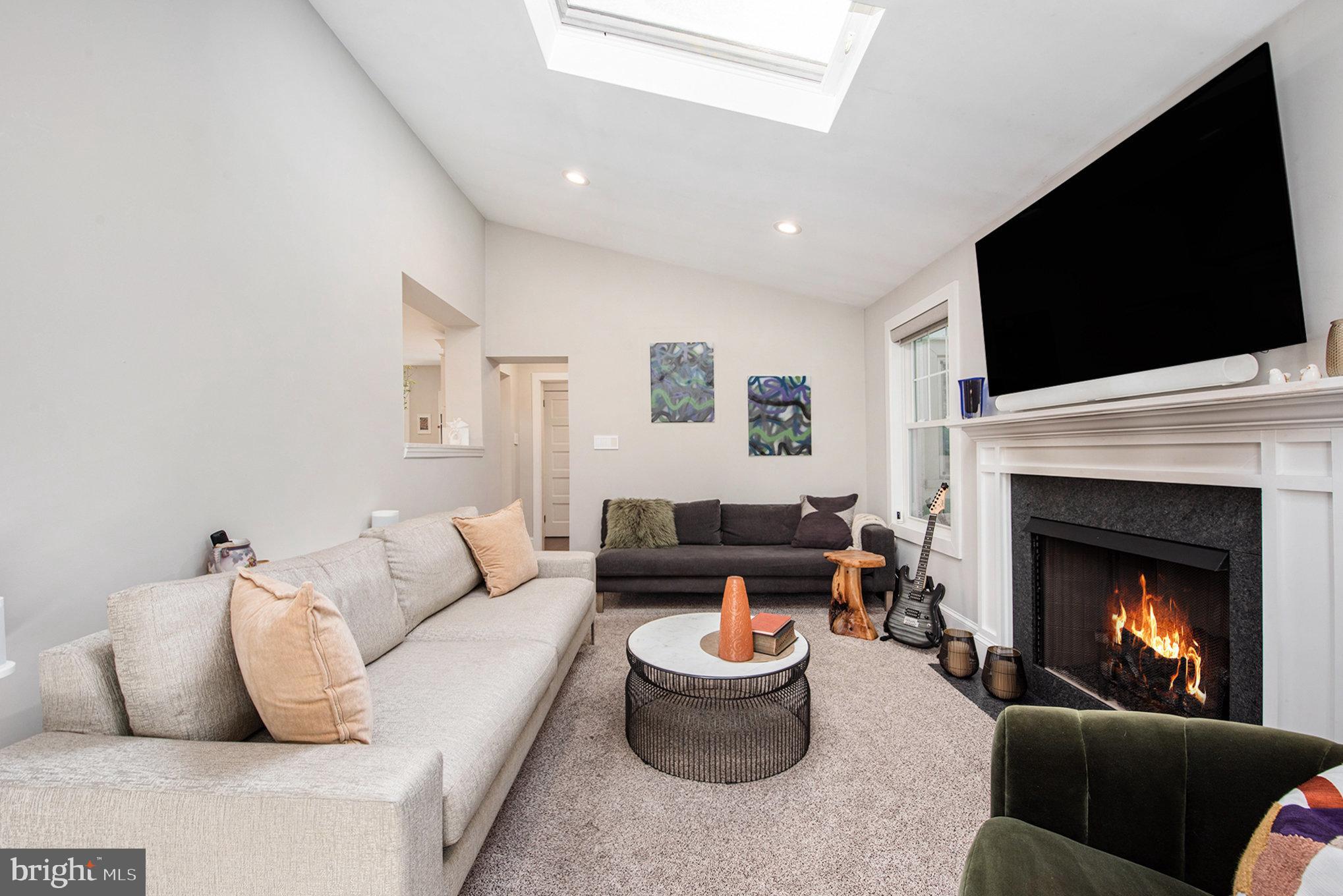 109 Willowburn Road Villanova, PA 19085 - Photo 13 of 65 a living room with furniture a flat screen tv and a fireplace