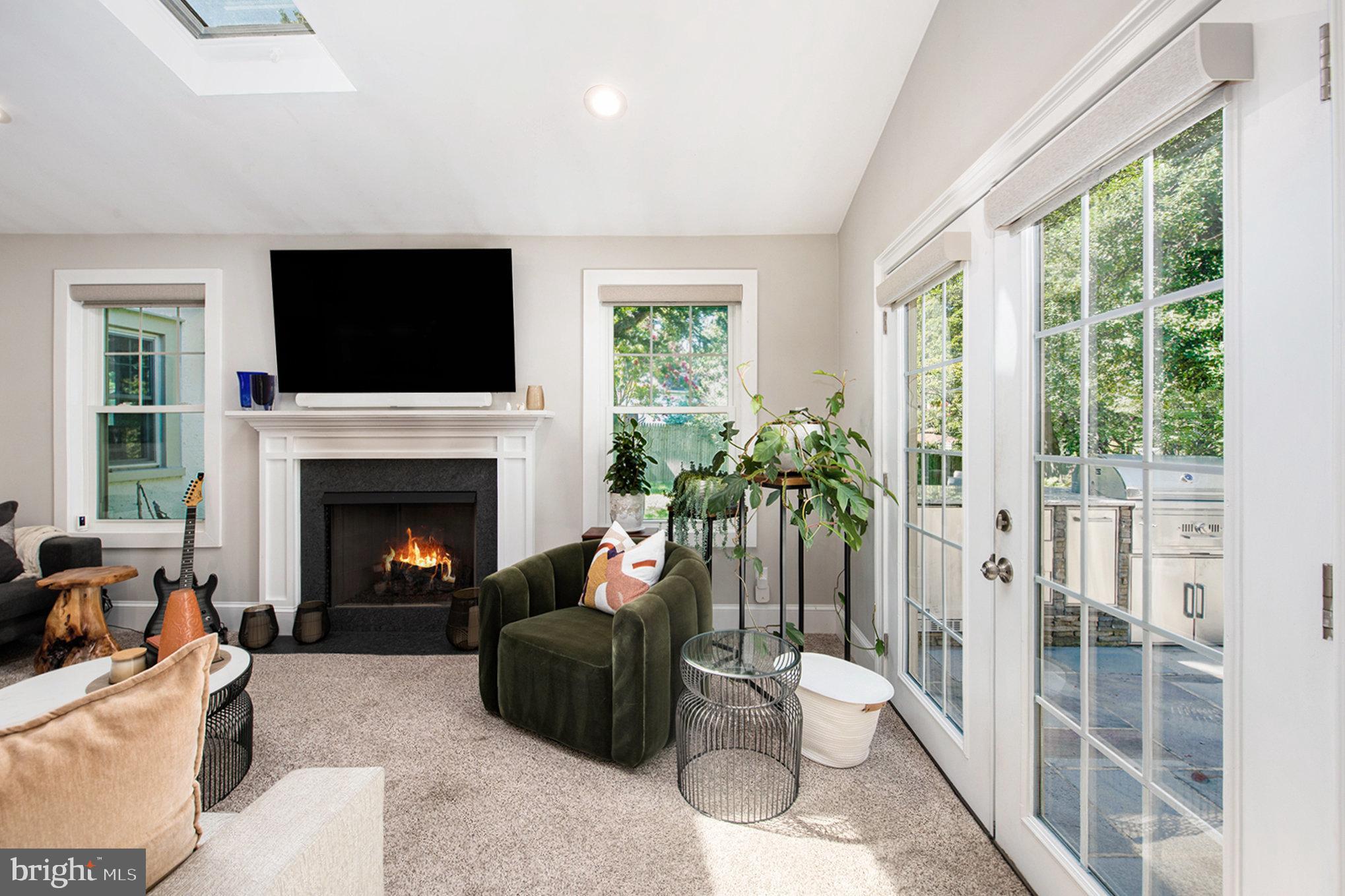 109 Willowburn Road Villanova, PA 19085 - Photo 14 of 65 a living room with furniture a flat screen tv and a fireplace