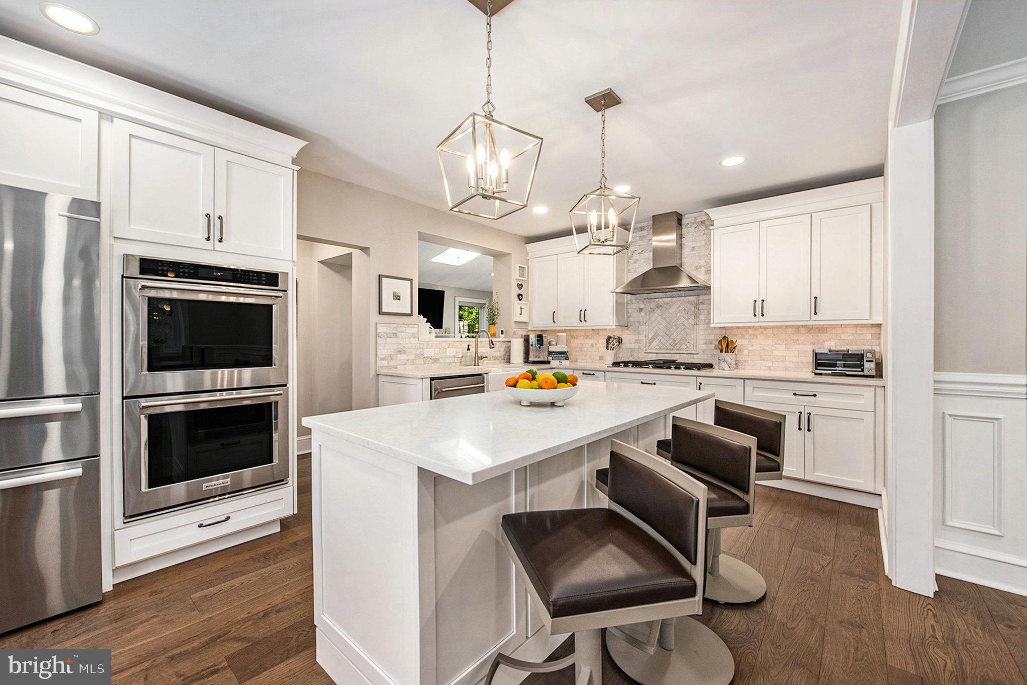 109 Willowburn Road Villanova, PA 19085 - Photo 18 of 65 a kitchen with kitchen island white cabinets and stainless steel appliances